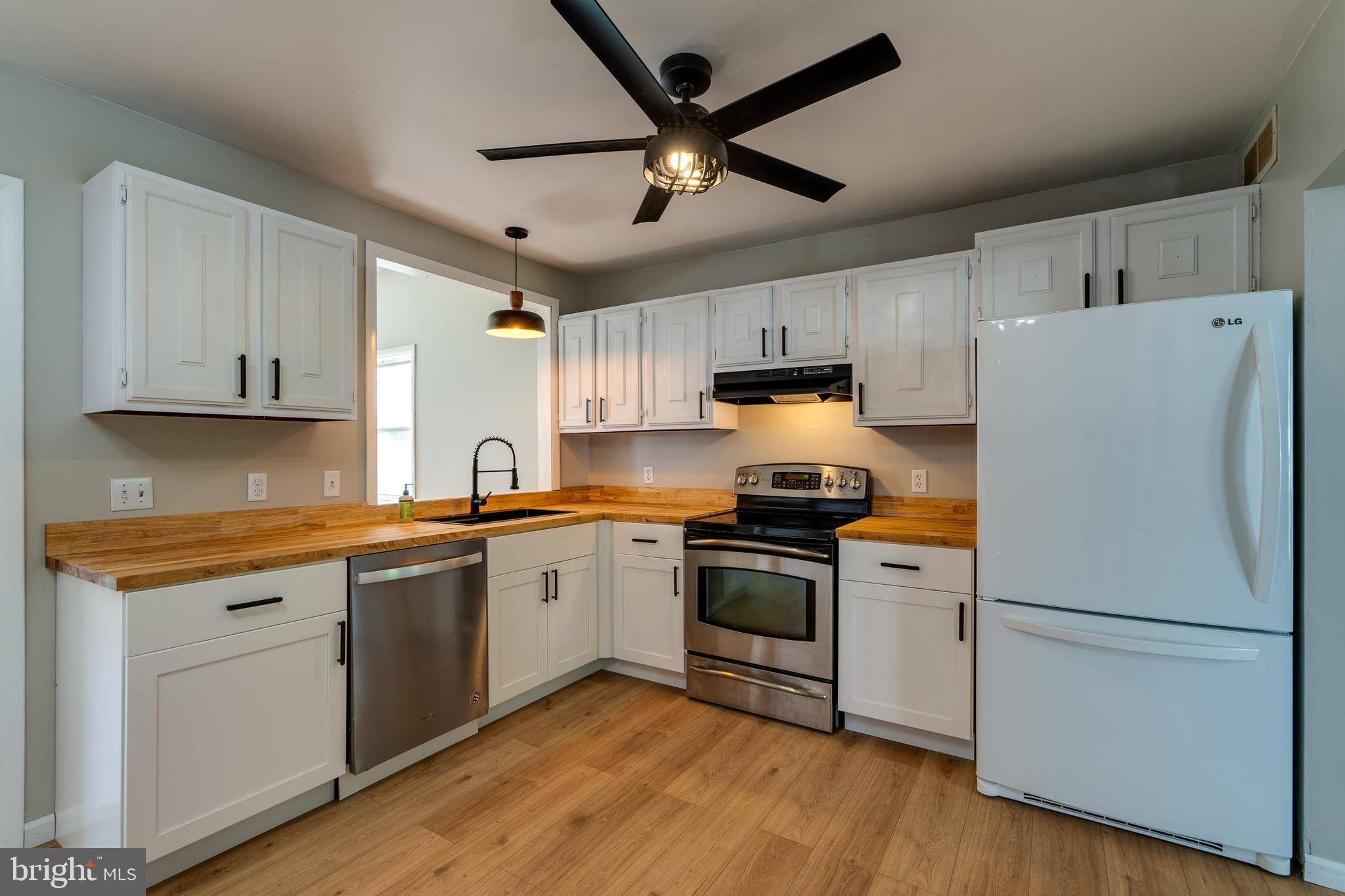 166 Pulte Road Lancaster, PA 17601 - Photo 14 of 41 a kitchen with stainless steel appliances granite countertop a refrigerator a stove a sink and white cabinets