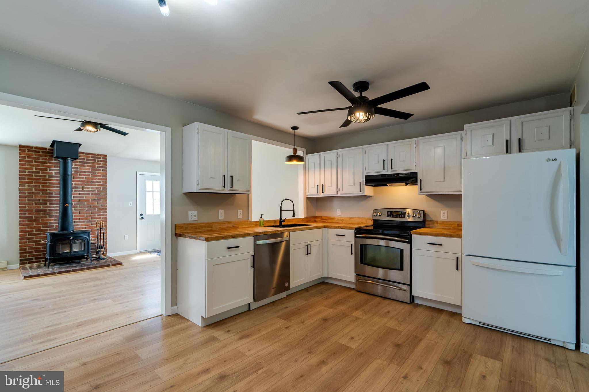 166 Pulte Road Lancaster, PA 17601 - Photo 17 of 41 a kitchen with granite countertop a refrigerator a stove a sink and white cabinets