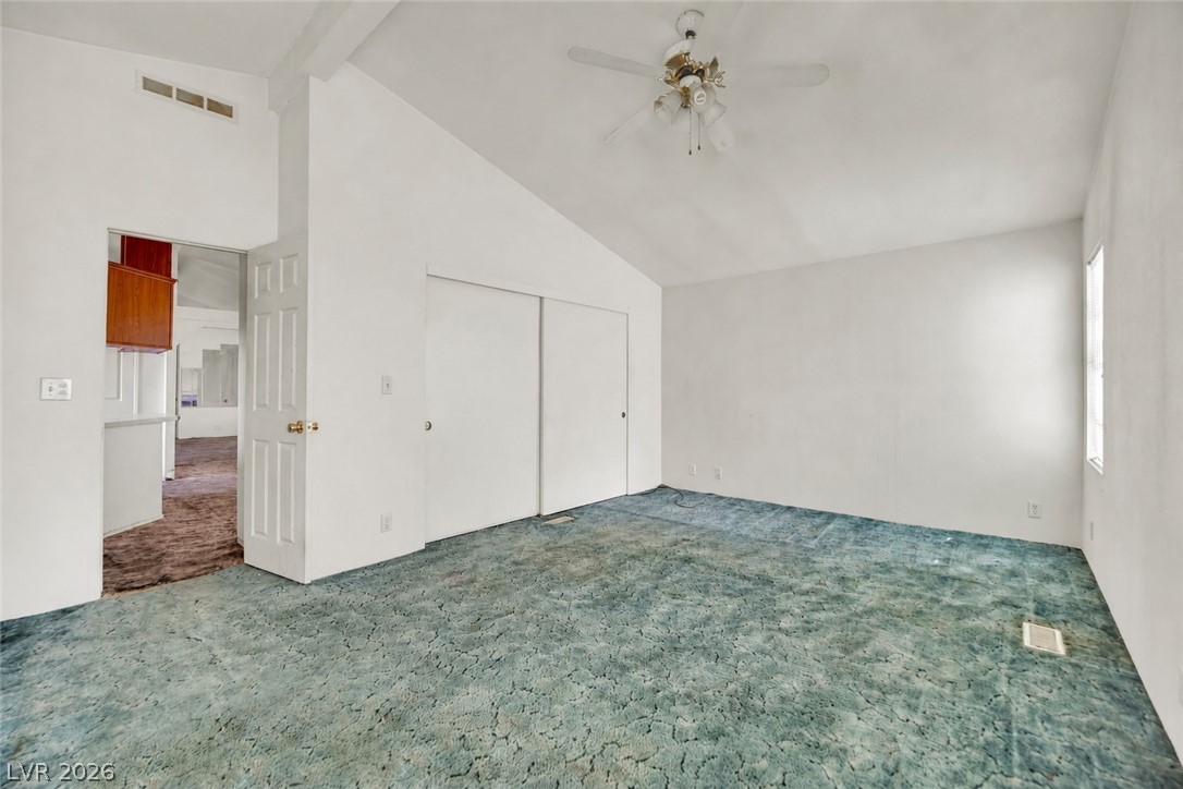 4361 Maple Road Pahrump, NV 89048 - Photo 16 of 35 A spacious bedroom features vaulted ceilings and a refreshing ceiling fan, ready for your personal touch.