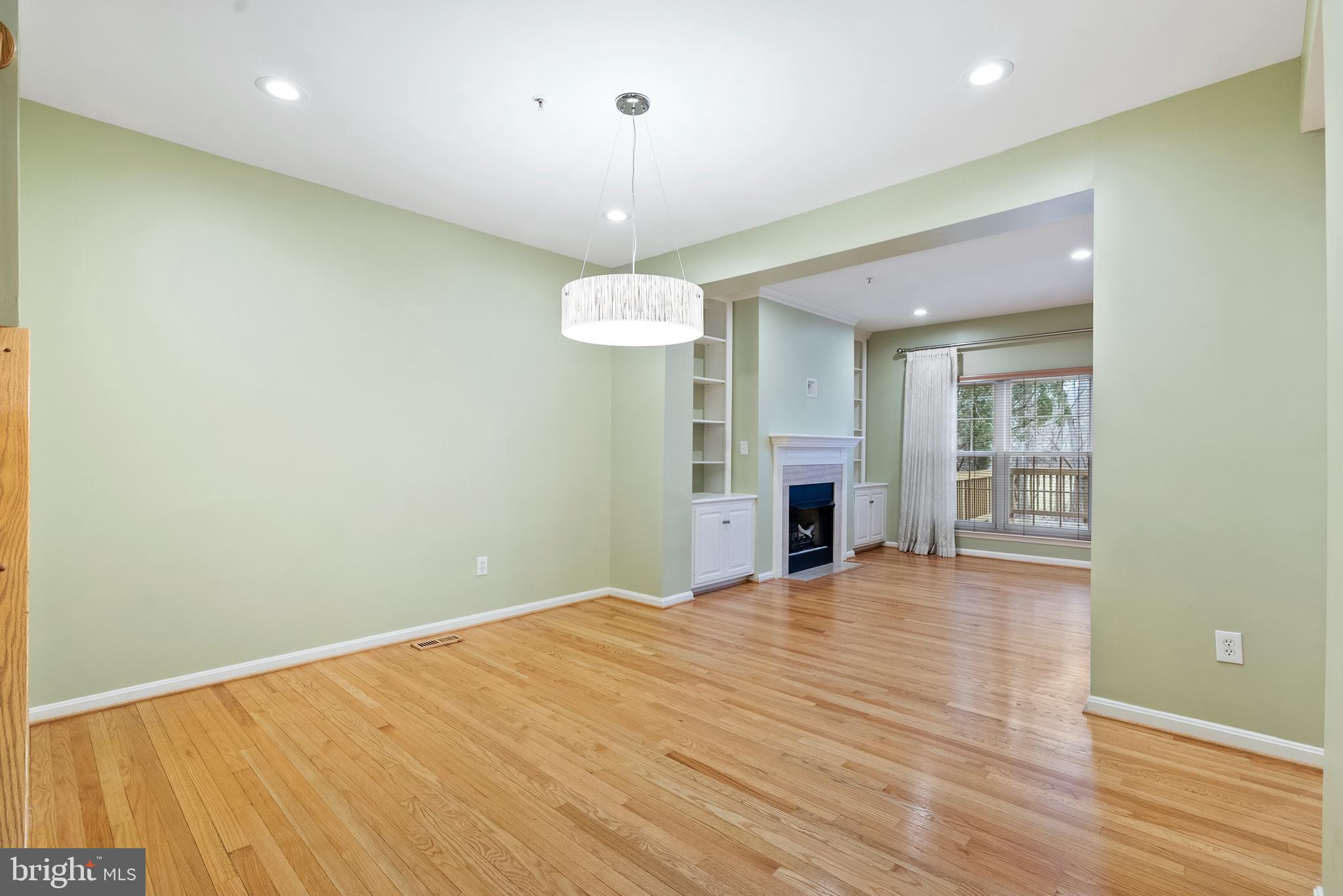 11928 St Francis Way Bowie, MD 20721 - Photo 13 of 48 an empty room with wooden floor and large window