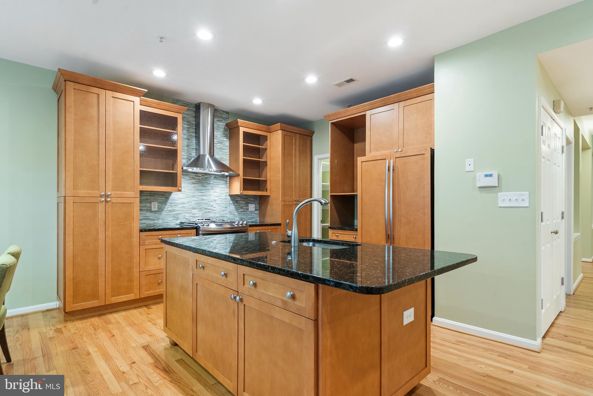 11928 St Francis Way Bowie, MD 20721 - Photo 17 of 48 a kitchen with stainless steel appliances granite countertop a sink and refrigerator