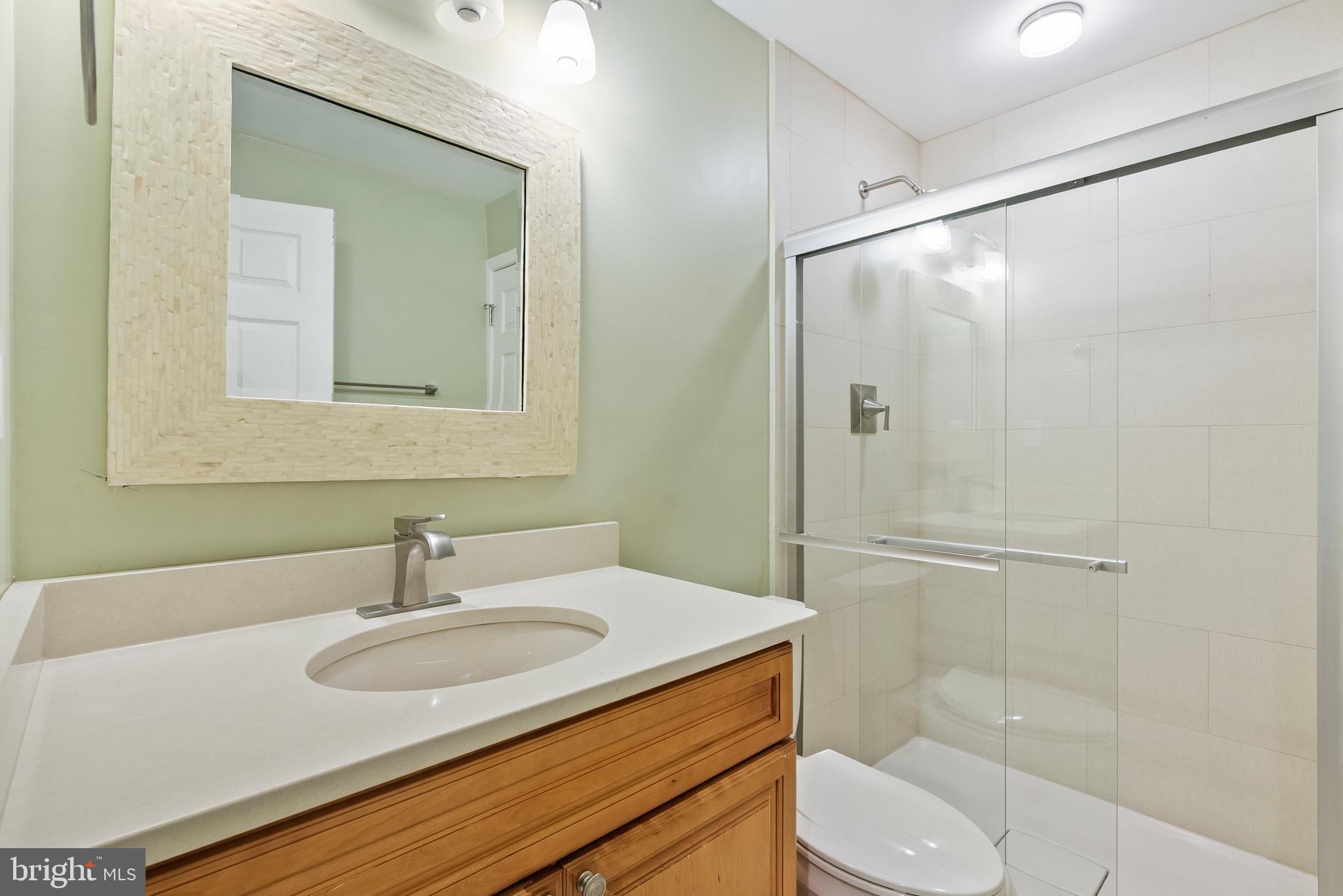 11928 St Francis Way Bowie, MD 20721 - Photo 43 of 48 a bathroom with a sink toilet vanity and shower