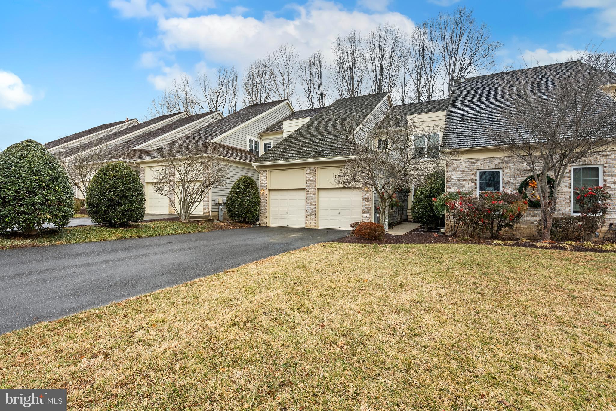 11928 St Francis Way Bowie, MD 20721 - Photo 7 of 48 a front view of a house with a yard and garage