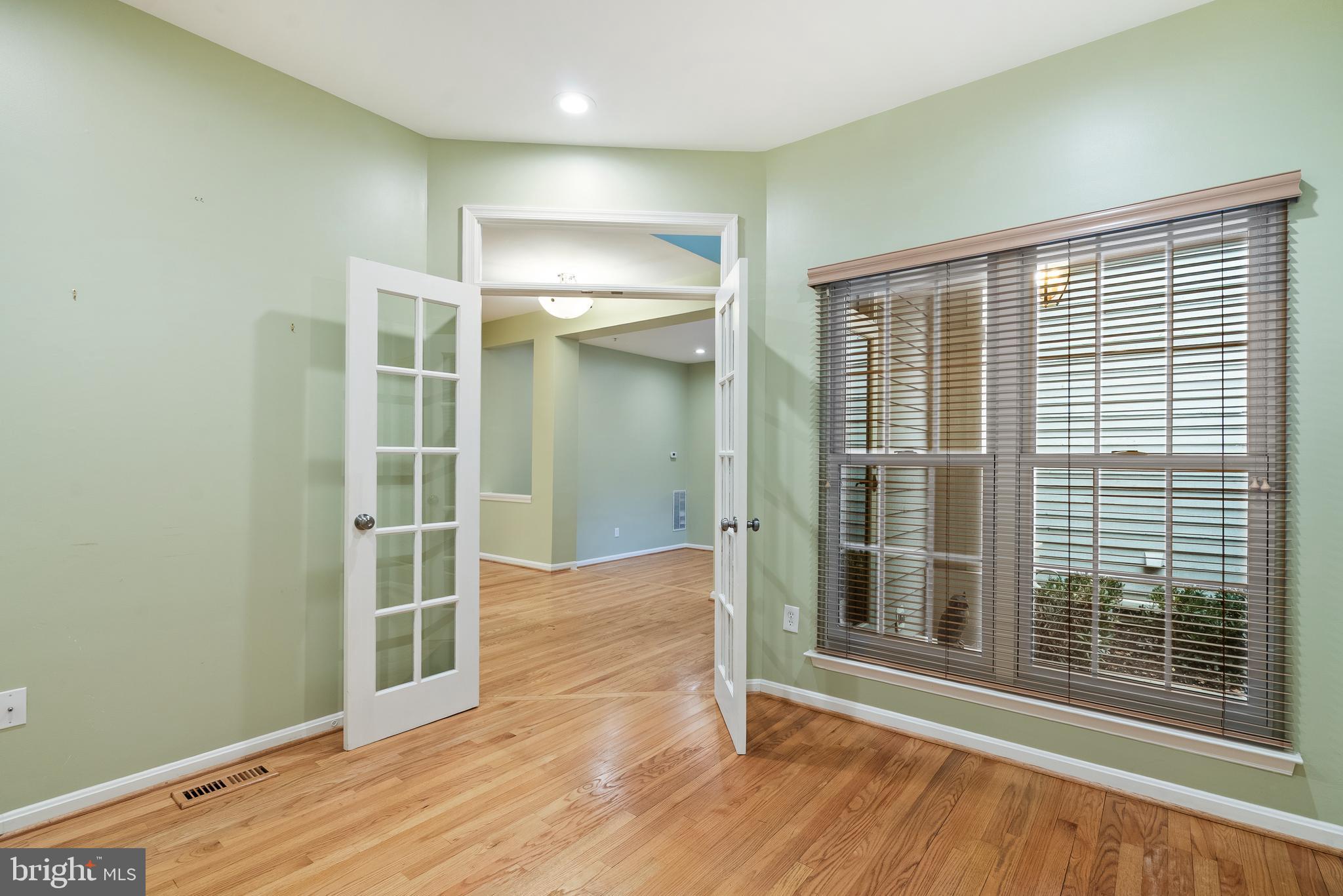 11928 St Francis Way Bowie, MD 20721 - Photo 10 of 48 an empty room with wooden floor and windows