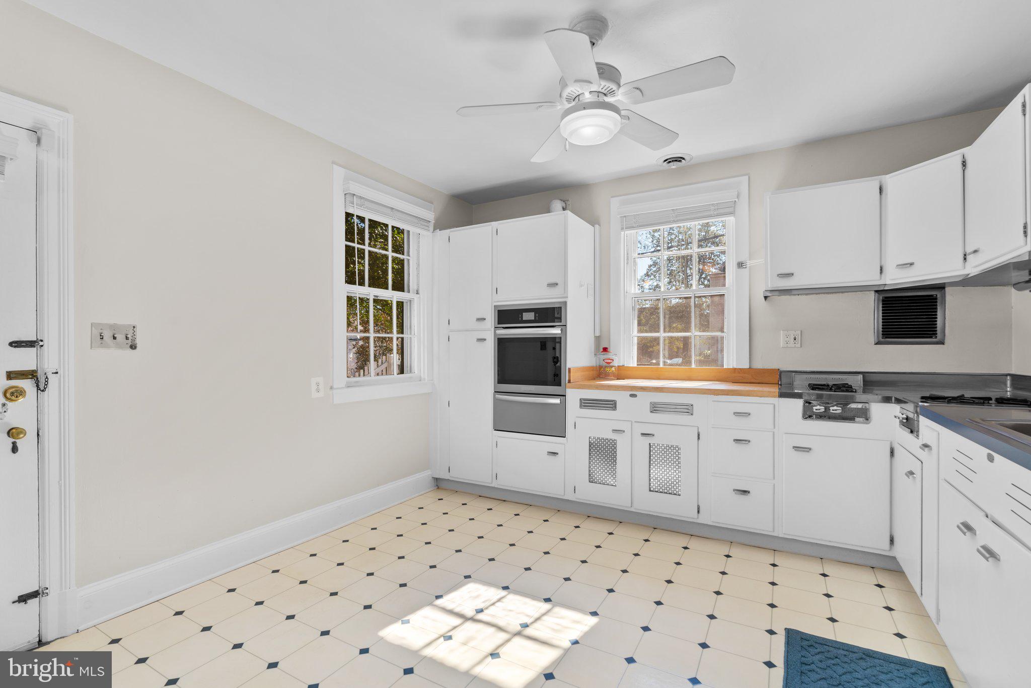 2 St Dunstans Garth Baltimore, MD 21212 - Photo 11 of 45 a kitchen with granite countertop a sink a stove a refrigerator a white stove with white cabinets and wooden floor