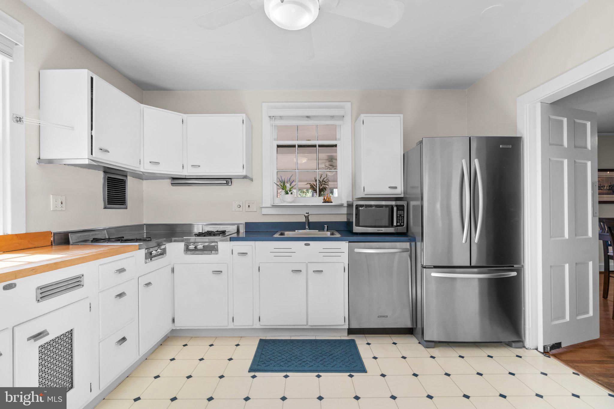 2 St Dunstans Garth Baltimore, MD 21212 - Photo 14 of 45 a kitchen with stainless steel appliances a stove a sink and a refrigerator