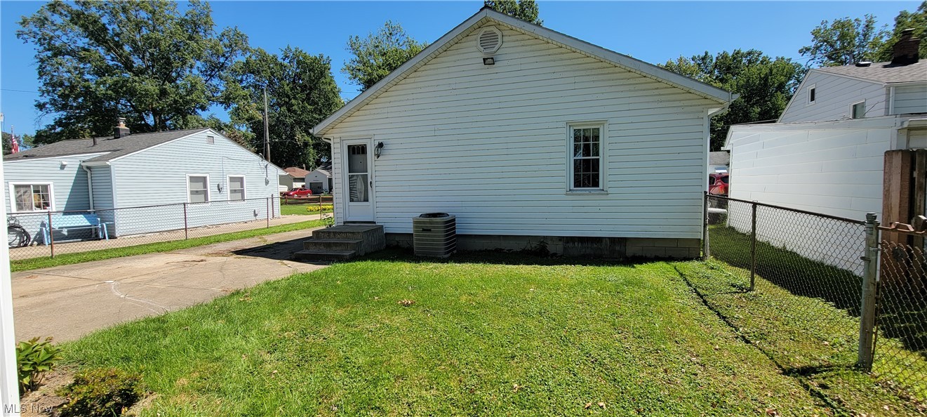 33703 Guilbert Road Eastlake, OH 44095 - Photo 5 of 32 View of property exterior with central AC unit and a lawn