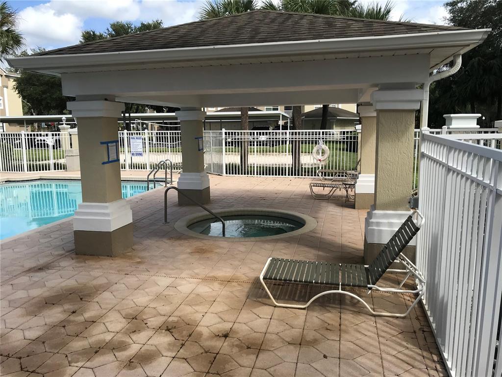 588 Brantley Terrace Way, Unit 303 Altamonte Springs, FL 32714 - Photo 23 of 24 a view of a patio with table and chairs with wooden floor and fence