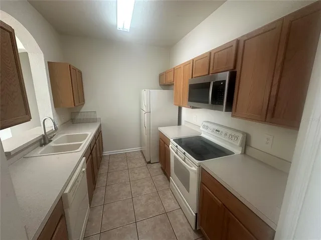 a kitchen with a stove sink and microwave