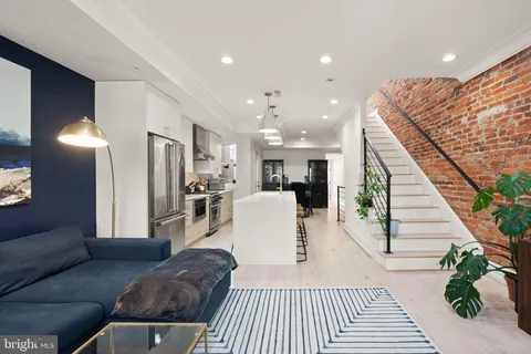 a living room with furniture and wooden floor