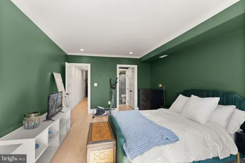 a bedroom with a bed and a large window