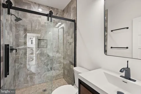 a bathroom with a sink toilet and shower