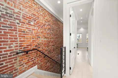 a spacious bedroom with a bed and a window