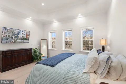 a bedroom with a bed and a night stand