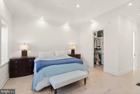 a bedroom with a bed and walk in closet