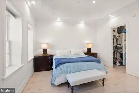 a bedroom with a bed and a couch