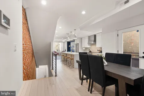a view of a dining room with furniture and wooden floor