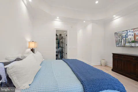 a bedroom with a bed and painting on the wall