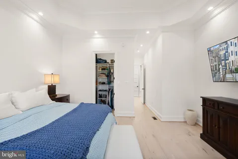 wooden floor with white cabinets