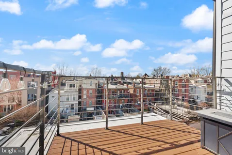a view of a balcony with wooden floor and city view