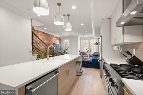 a kitchen with a stove a sink and a refrigerator