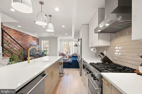 a kitchen with a stove and a chandelier