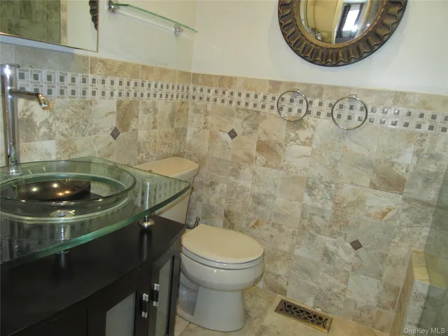 a bathroom with a sink a toilet and a mirror