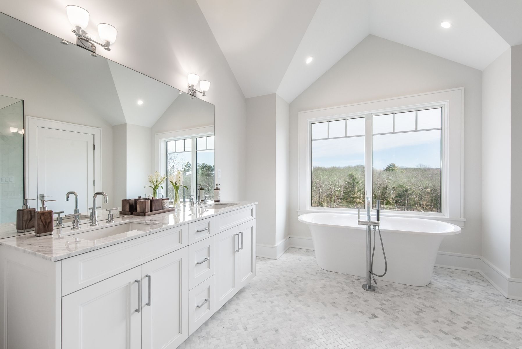 159 Middle Highway East Hampton, NY 11937 - Photo 11 of 18 a bathroom with a sink a large mirror and a bathtub next to a window
