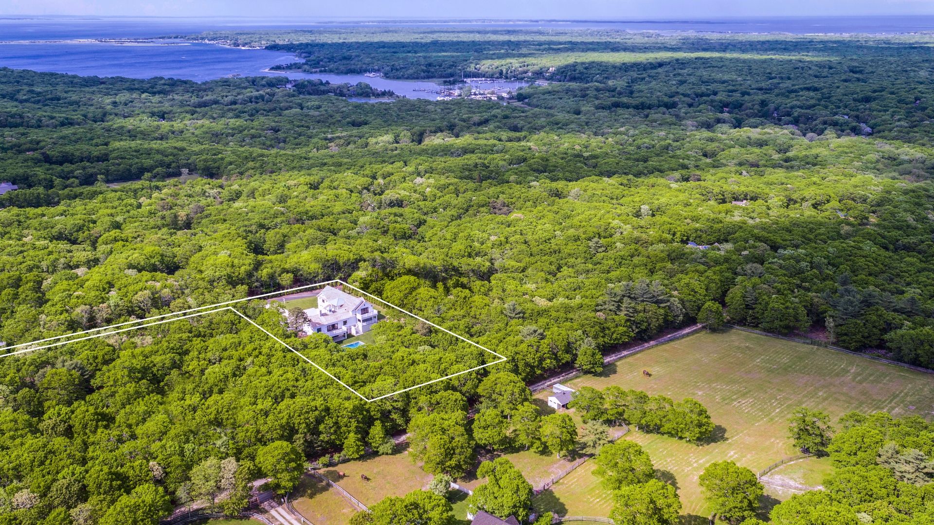 159 Middle Highway East Hampton, NY 11937 - Photo 2 of 18 a view of a lush green field with an ocean