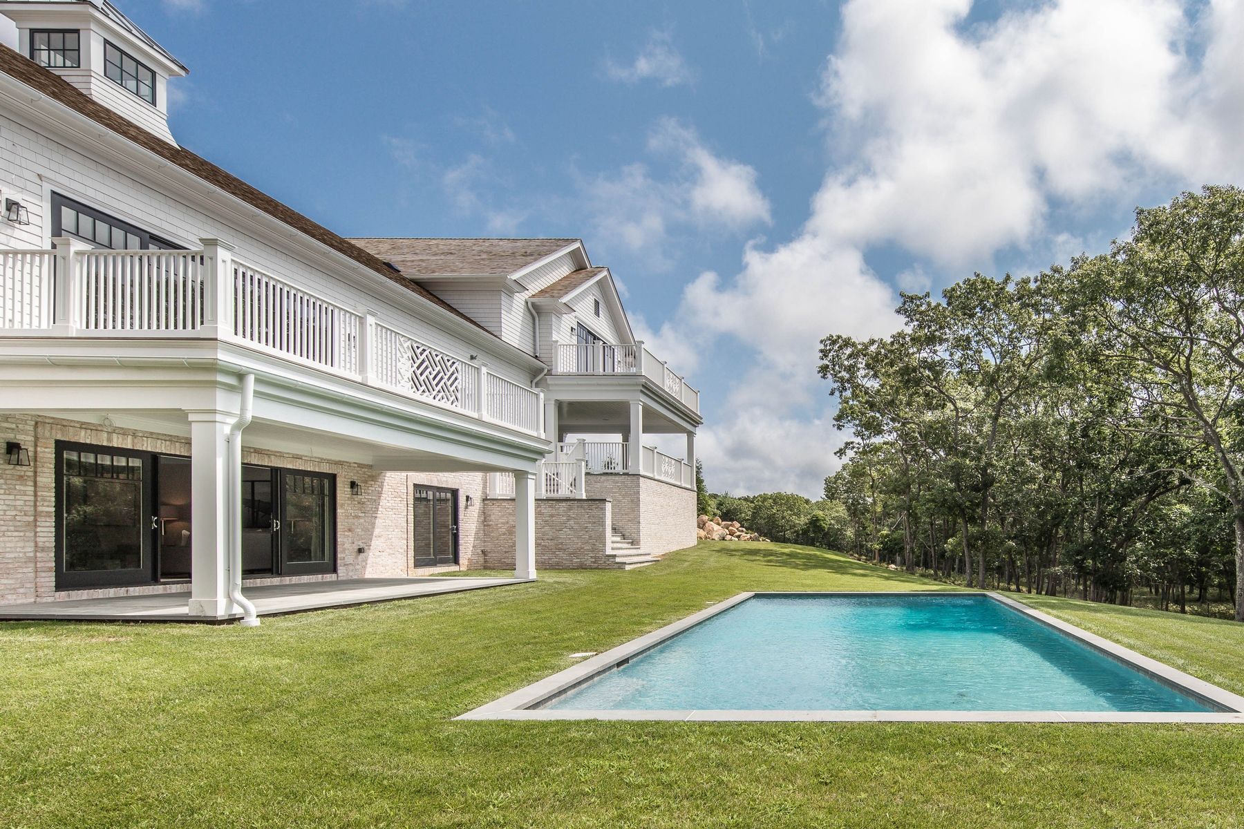 159 Middle Highway East Hampton, NY 11937 - Photo 3 of 18 a view of an house with swimming pool and porch