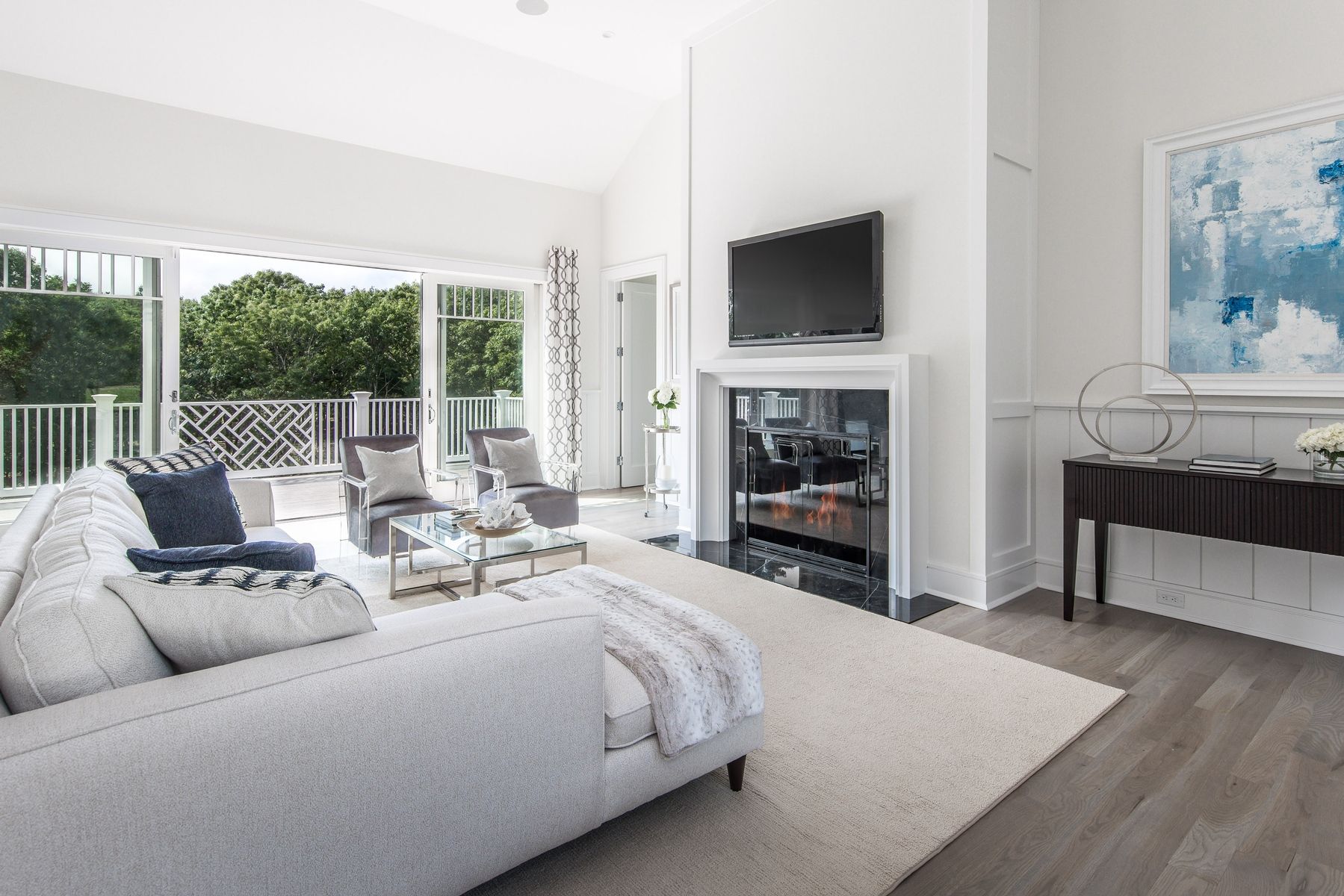 159 Middle Highway East Hampton, NY 11937 - Photo 5 of 18 a living room with furniture a fireplace and a flat screen tv