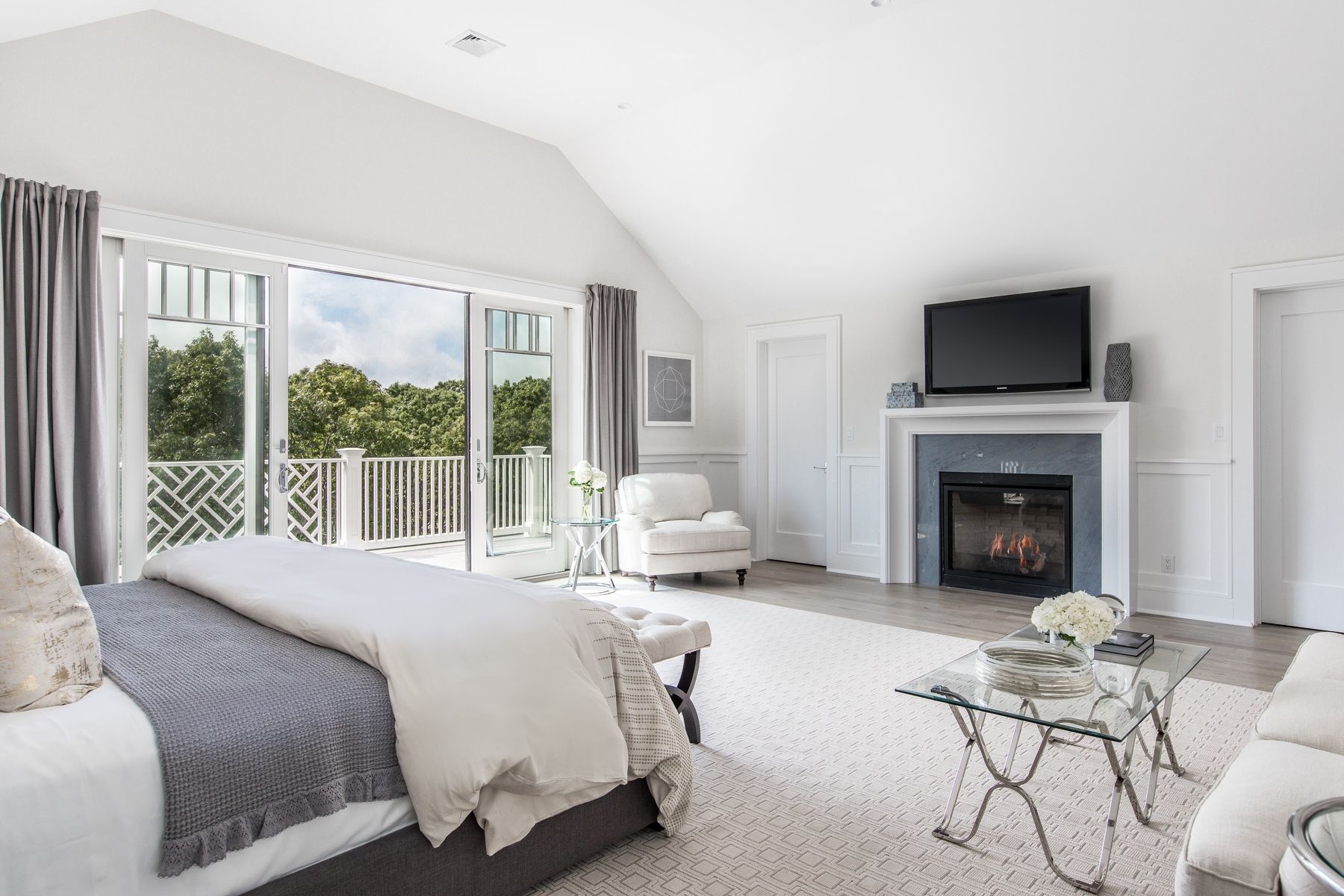 159 Middle Highway East Hampton, NY 11937 - Photo 7 of 18 a bedroom with a bed and a fireplace