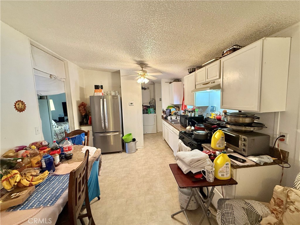 22020 Nisqually Road, Unit 65 Apple Valley, CA 92308 - Photo 6 of 14 a living room with furniture and a table