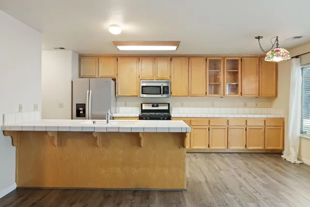 a kitchen with kitchen island a sink appliances and cabinets