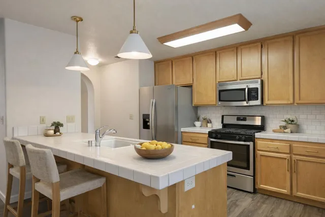 a kitchen with a sink a stove and refrigerator