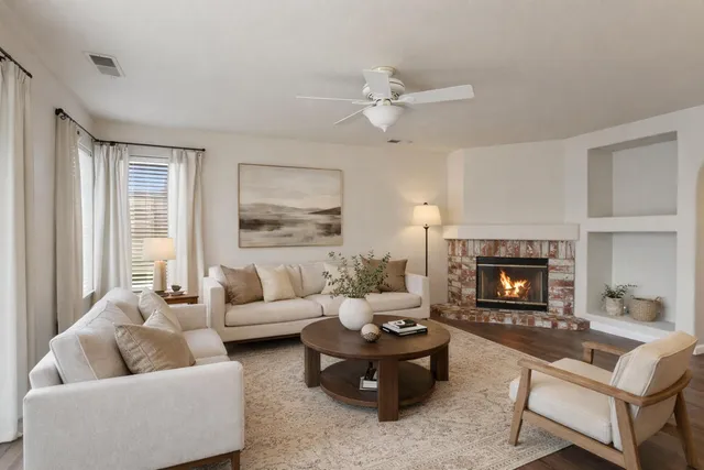 a living room with furniture and a fireplace