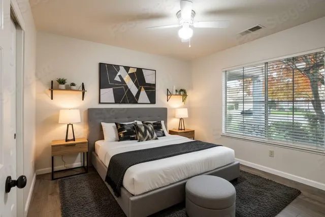 a bedroom with a bed and a window