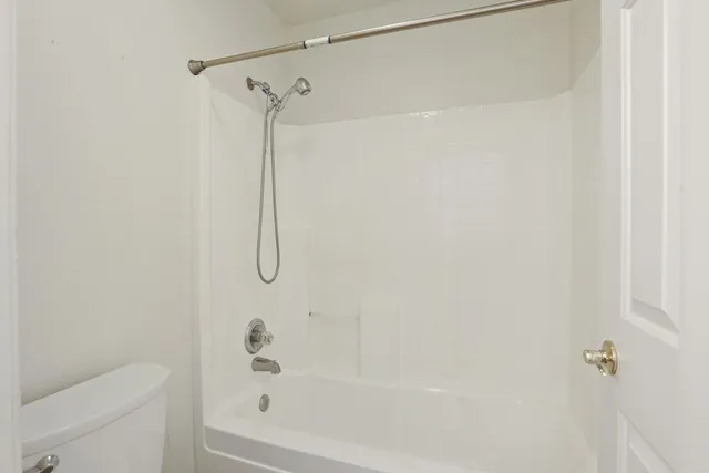 a bathroom with a shower and a toilet