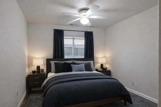 a bedroom with a bed and a window