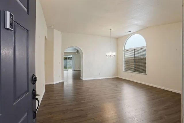 a view of a room with wooden floor and a window