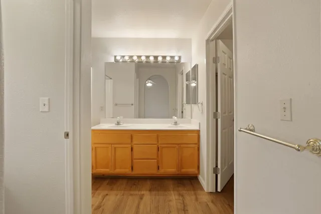 a spacious bathroom with a double vanity sink and a mirror