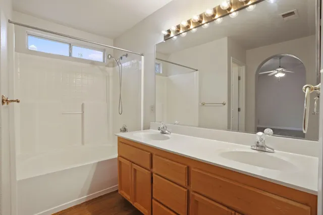 a bathroom with a sink double vanity and a mirror