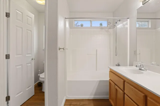 a bathroom with a shower sink and mirror