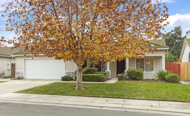 a front view of a house with a garden