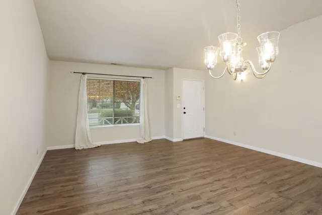 a view of wooden floor and windows in a room