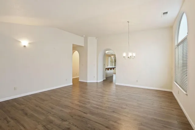 a view of a room with wooden floor and window