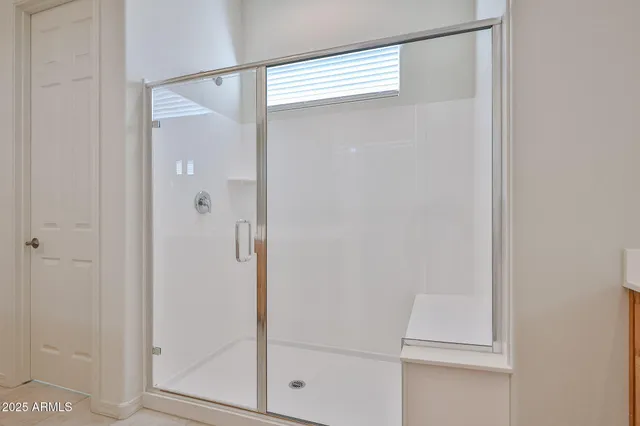 a bathroom with a glass shower door