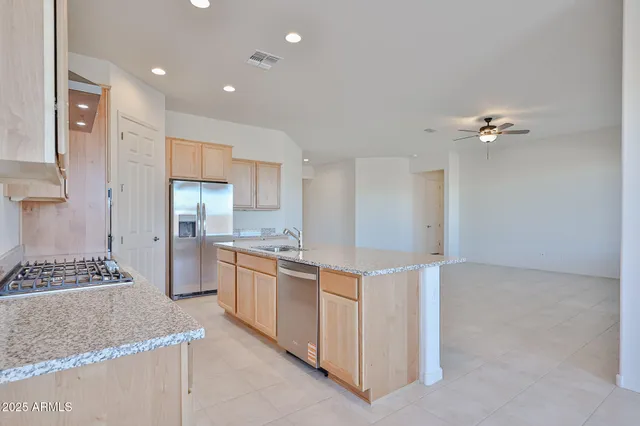 a open kitchen with cabinets stove and refrigerator
