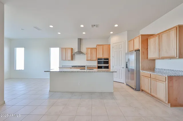 a large kitchen with stainless steel appliances lots of counter top space