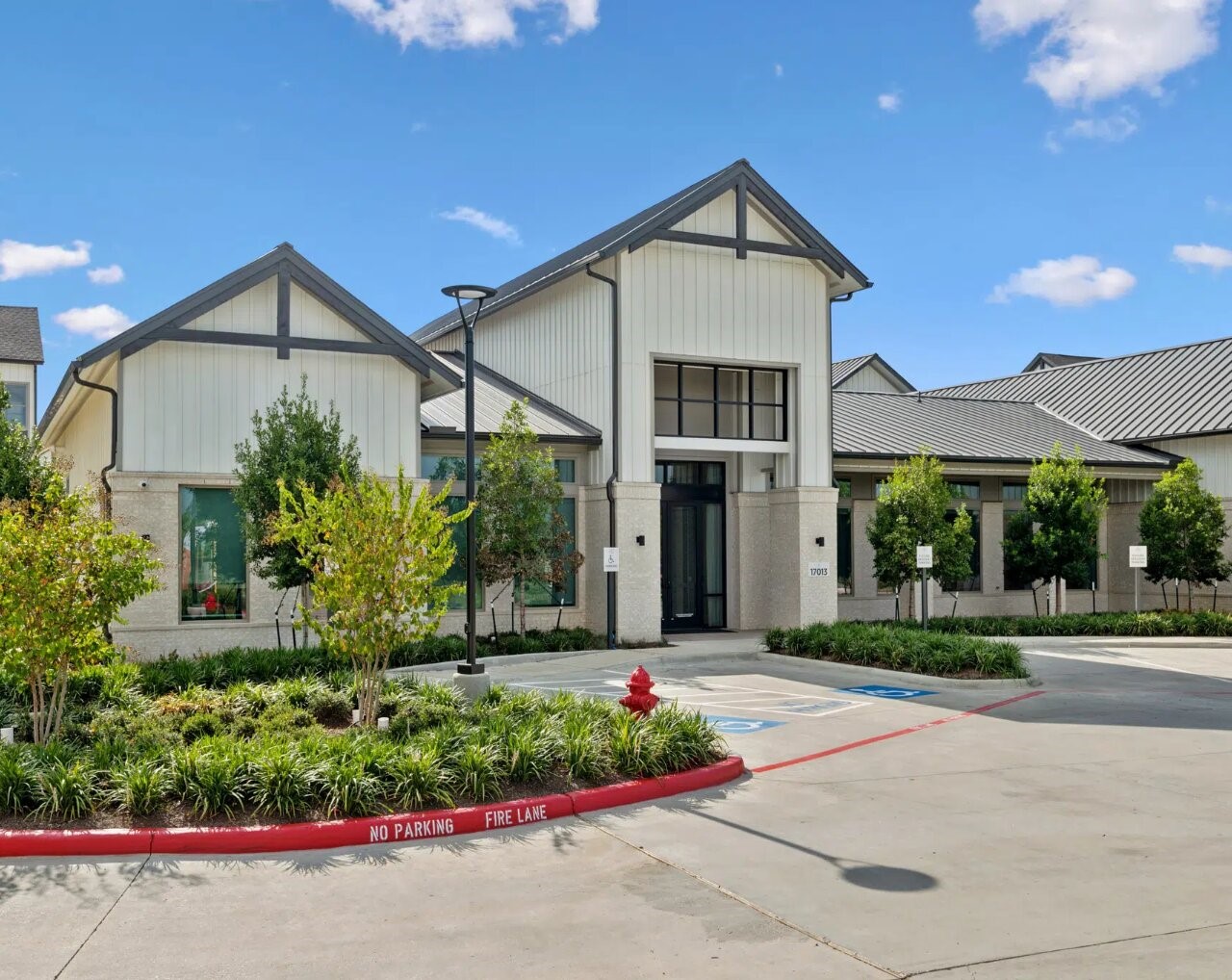 17013 Becker Road, Unit 7309 Hockley, TX 77447 - Photo 2 of 18 a front view of a house with a yard and potted plants